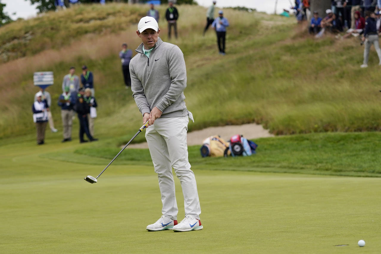 Rory McIlroy, of Northern Ireland, reacts after missing a putt on the third hole during the final r...