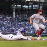 
              Chicago Cubs' Christopher Morel dives safely in to first on an infield single as Cincinnati Reds starting pitcher Graham Ashcraft fields the throw from first baseman Joey Votto during the second inning of a baseball game Thursday, June 30, 2022, in Chicago. (AP Photo/Charles Rex Arbogast)
            