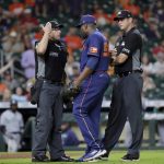 
              Houston Astros relief pitcher Hector Neris, middle, protests his ejection with umpires Chris Guccione, left, and Jordan Baker, right, after Neris threw at the head of Seattle Mariners batter Eugenio Suarez during the ninth inning of a baseball game Monday, June 6, 2022, in Houston. Neris was ejected from the game for the pitch, which happened on the next batter after Neris hit Seattle Mariners' Ty France, causing both dugouts to empty with ejections on both teams. (AP Photo/Michael Wyke)
            