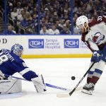 
              Tampa Bay Lightning goaltender Andrei Vasilevskiy (88) deflects a shot by Colorado Avalanche left wing J.T. Compher (37) during the second period of Game 6 of the NHL hockey Stanley Cup Finals on Sunday, June 26, 2022, in Tampa, Fla. (AP Photo/Phelan Ebenhack)
            