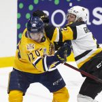 
              Shawinigan Cataractes' Olivier Nadeau (20) takes a shot to the head from Hamilton Bulldogs' Artem Grushnikov during first-period Memorial Cup hockey game action in Saint John, New Brunswick, Monday, June 27, 2022. (Ron Ward/The Canadian Press via AP)
            