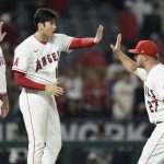 
              Los Angeles Angels' David MacKinnon, from left, Shohei Ohtani and Mike Trout celebrate the team's 4-3 win in a baseball game against the Chicago White Sox Monday, June 27, 2022, in Anaheim, Calif. (AP Photo/Jae C. Hong)
            
