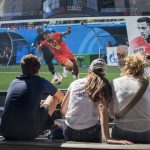 
              FILE - French soccer fans watch France play Belgium in a World Cup semifinal soccer game on a gigantic screen in New York's Times Square, on July 10, 2018, in New York. U.S. cities and states have lined up with tax breaks and millions of dollars in both public and private investments for a chance at hosting 2026 FIFA World Cup games, set to be announced Thursday, June 16, 2022. (AP Photo/Mary Altaffer, File)
            