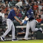 
              Seattle Mariners' Ty France (23) celebrates with third base coach Manny Acta after hitting a home run against the Houston Astros during the fourth inning of a baseball game Wednesday, June 8, 2022, in Houston. (AP Photo/David J. Phillip)
            