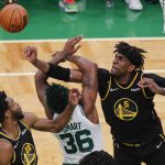 
              Golden State Warriors center Kevon Looney (5) and forward Andrew Wiggins (22) battle for a rebound against Boston Celtics guard Marcus Smart (36) during the fourth quarter of Game 4 of basketball's NBA Finals, Friday, June 10, 2022, in Boston. (AP Photo/Michael Dwyer)
            