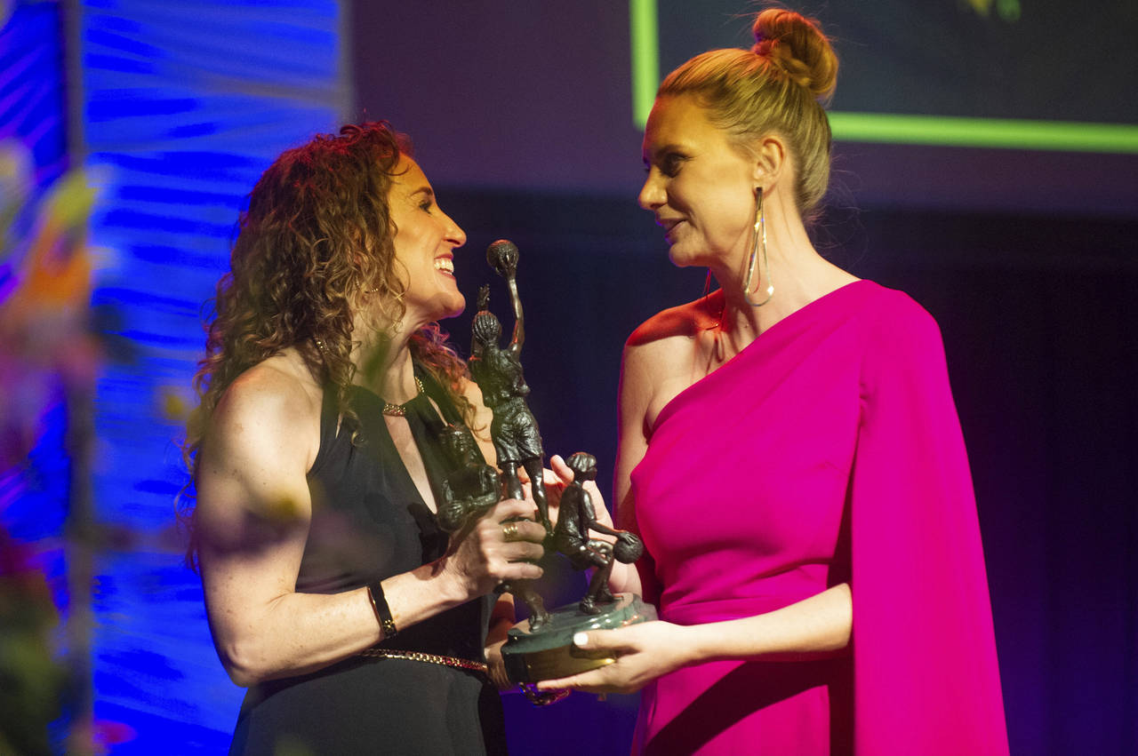 Penny Taylor, right, accepts her Eastman Trophy during the Women's Basketball Hall of Fame inductio...