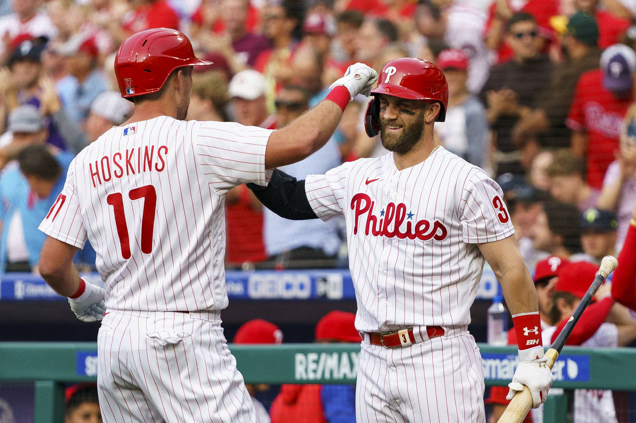 Philadelphia Phillies' Rhys Hoskins, left, celebrates his home run with Bryce Harper, right, during...