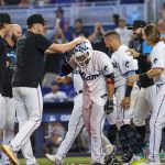 
              Miami Marlins' Nick Fortes, center, celebrates with teammates after hitting a walkoff solo home run during the ninth inning of a baseball game against the New York Mets, Sunday, June 26, 2022, in Miami. (David Santiago/Miami Herald via AP)
            