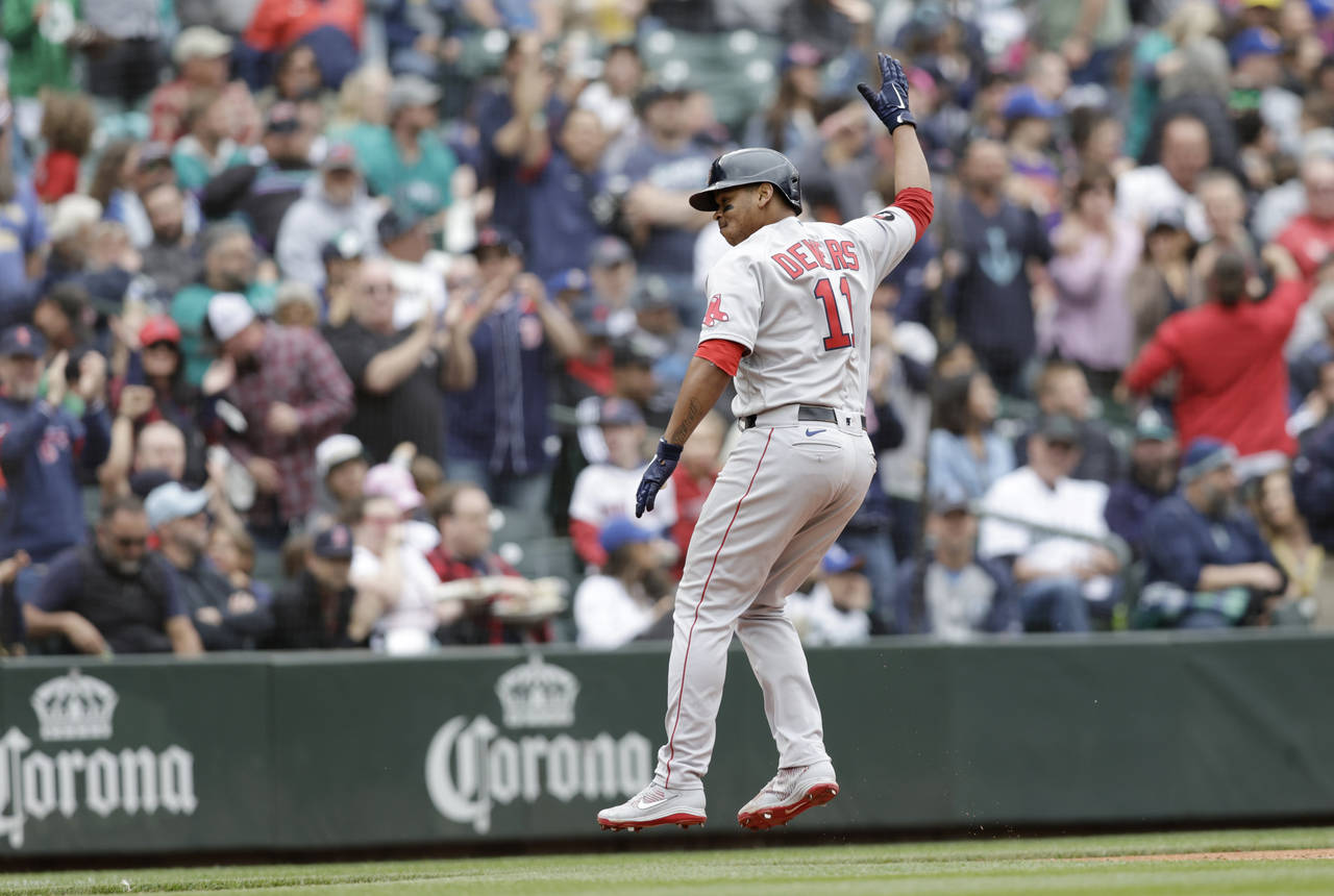 Boston Red Sox's Rafael Devers celebrates as he runs home after hitting a two-run home run on a pit...