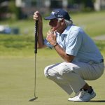 
              Fred Couples lines up on putt on the 18th green during the first round of the PGA Tour Champions Principal Charity Classic golf tournament, Friday, June 3, 2022, in Des Moines, Iowa. (AP Photo/Charlie Neibergall)
            