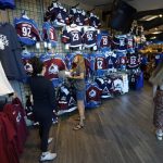 
              People look for merchandise in the team store in Ball Arena, Monday, June 27, 2022, in Denver after the Colorado Avalanche defeated the Tampa Bay Lightning in Game 6 of the Stanley Cup Final to claim the NHL hockey championship. (AP Photo/David Zalubowski)
            