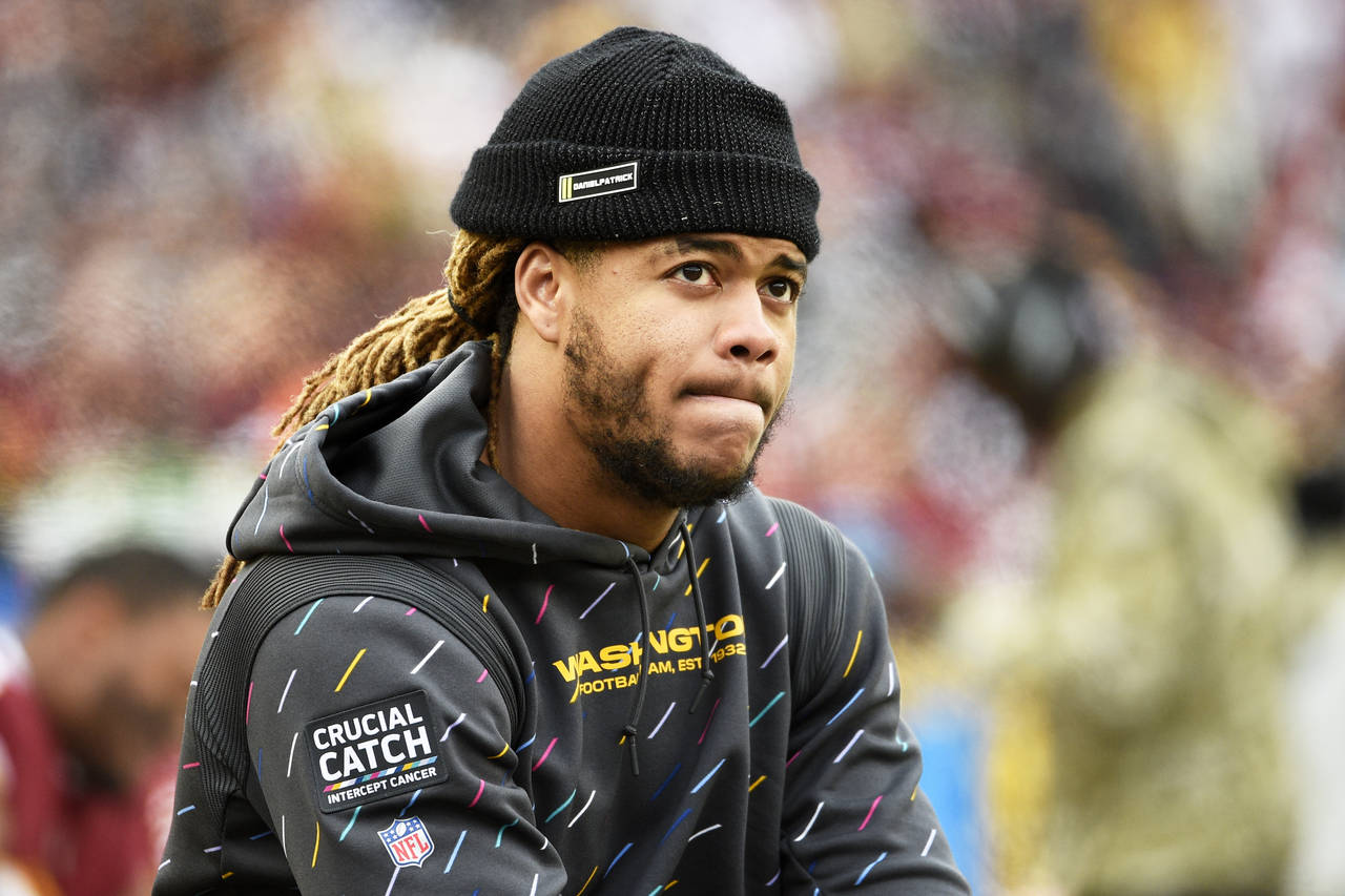 FILE - Washington defensive end Chase Young sits on the bench after being injured during an NFL foo...