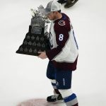 
              Colorado Avalanche defenseman Cale Makar skates with the Conn Smythe Trophy for being the playoffs MVP of the NHL hockey Stanley Cup Finals against the Tampa Bay Lightning on Sunday, June 26, 2022, in Tampa, Fla. (AP Photo/John Bazemore)
            
