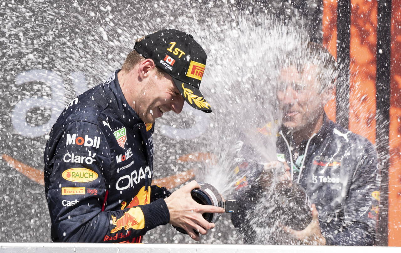 Red Bull Racing Max Verstappen, of the Netherlands, is sprayed with champagne by members of his tea...