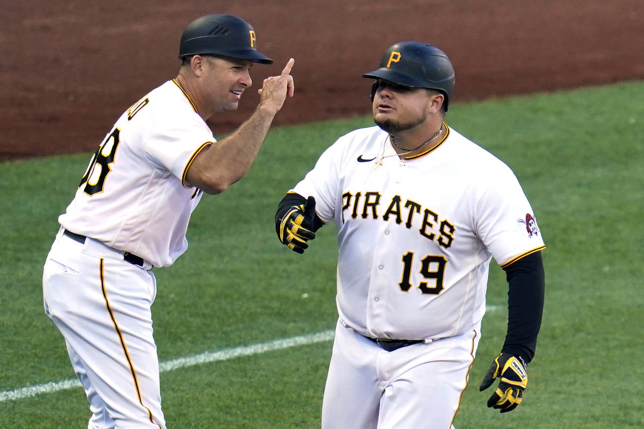 Pittsburgh Pirates' Daniel Vogelbach (19) is greeted by third base coach Mike Rabelo as he rounds t...