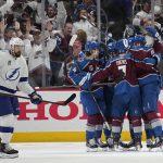
              Colorado Avalanche players celebrate a goal by Valeri Nichushkin as Tampa Bay Lightning left wing Nicholas Paul, left, skates past during the first period in Game 2 of the NHL hockey Stanley Cup Final on Saturday, June 18, 2022, in Denver. (AP Photo/John Locher)
            