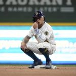 
              Milwaukee Brewers' Kolten Wong sits on second after hitting a double during the eighth inning of a baseball game against the San Diego Padres Friday, June 3, 2022, in Milwaukee. (AP Photo/Morry Gash)
            