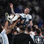 
              Argentina's players celebrate with Lionel Messi, top, after winning the Finalissima soccer match between Italy and Argentina at Wembley Stadium in London , Wednesday, June 1, 2022. (AP Photo/Matt Dunham)
            