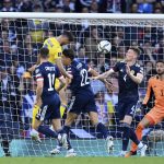
              Ukraine's Roman Yaremchuk, top left, scores their side's second goal during the World Cup 2022 qualifying play-off soccer match between Scotland and Ukraine at Hampden Park stadium in Glasgow, Scotland, Wednesday, June 1, 2022. (Malcolm Mackenzie/PA via AP)
            