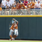 
              Texas center fielder Douglas Hodo (7) makes a catch with right fielder Dylan Campbell (8) against Texas A&M in the first inning during an NCAA College World Series baseball game Sunday, June 19, 2022, in Omaha, Neb. (AP Photo/John Peterson)
            