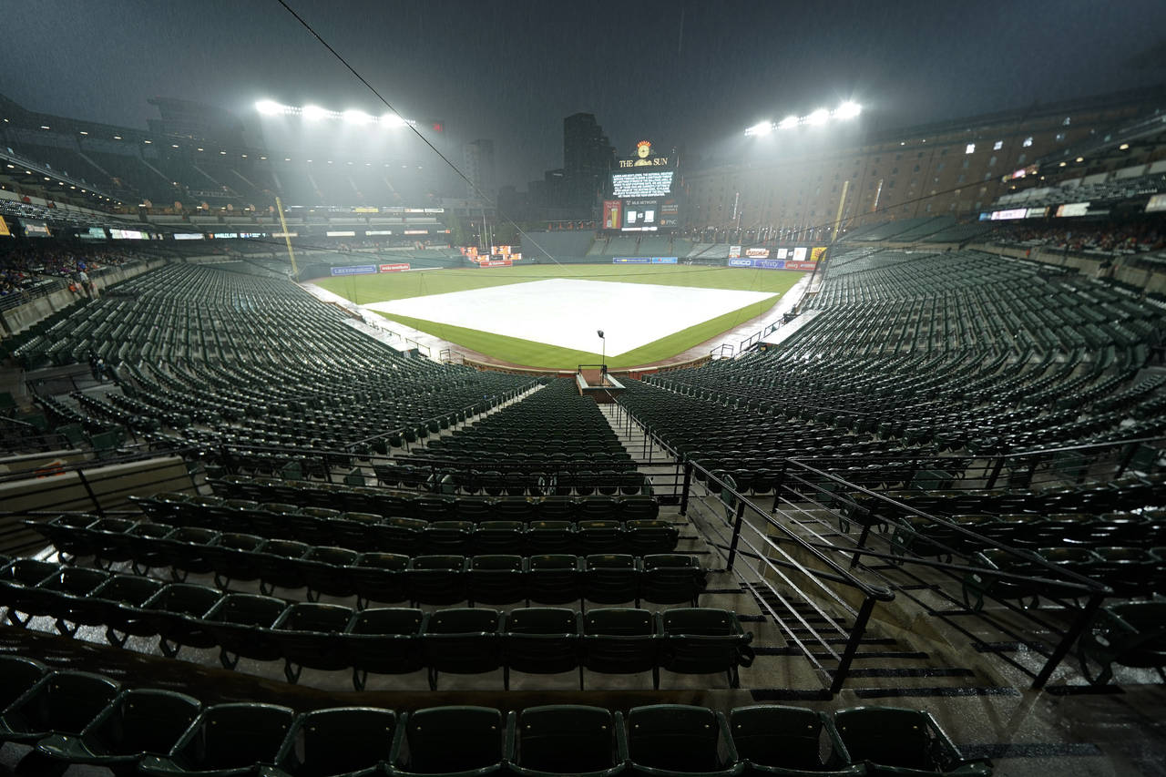 Rain falls over Oriole Park at Camden Yards during a delay of a baseball game between the Baltimore...