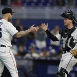 
              Miami Marlins relief pitcher Tanner Scott (66) and catcher Nick Fortes congratulate each other after the Marlins beat the Colorado Rockies 3-2 during a baseball game, Thursday, June 23, 2022, in Miami. (AP Photo/Wilfredo Lee)
            
