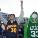 
              Golden State Warriors fan Andrew Pai, left, of San Jose, Calif., cheers on his team while standing next to Boston Celtics fan Kenneth Chakang, of Cupertino, Calif., at a watch party Thursday, June 16, 2022, in San Francisco for Game 6 of basketball's NBA Finals in Boston. (AP Photo/D. Ross Cameron)
            