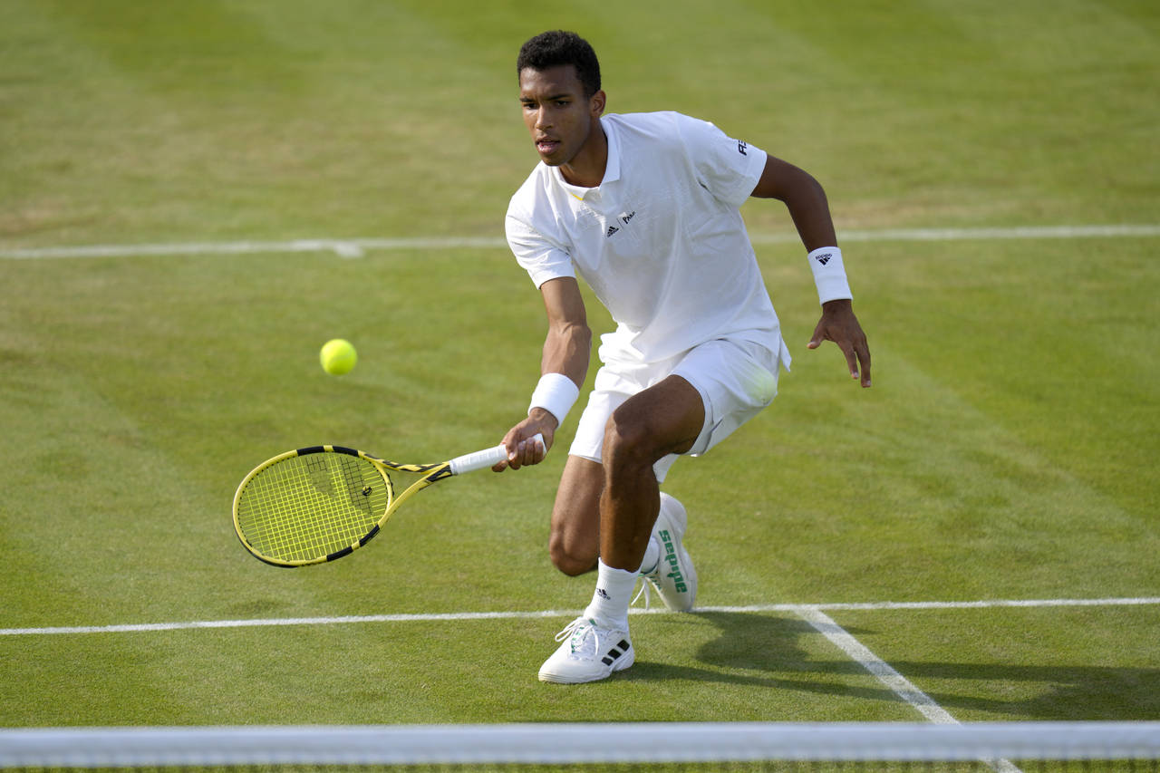 Canada's Felix Auger-Aliassime returns the ball to Maxime Cressy of the US during their singles ten...