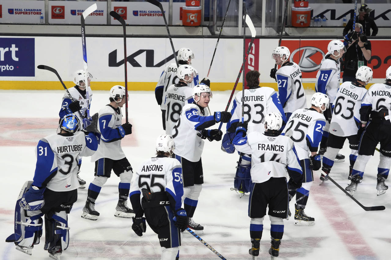 Members of the Saint John Sea Dogs celebrate a win over the Shawinigan Cataractes in a Memorial Cup...