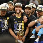 
              Golden State Warriors guard Stephen Curry, center, celebrates with teammates as he holds the Bill Russell Trophy for Most Valuable Player after the Warriors beat the Boston Celtics in Game 6 to win basketball's NBA Finals, Thursday, June 16, 2022, in Boston. (AP Photo/Steven Senne)
            