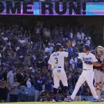 
              Los Angeles Dodgers' Trea Turner, center, is congratulated by Chris Taylor, left, after hitting a two-run home run as Cleveland Guardians catcher Austin Hedges stands at the plate during the second inning of a baseball game Saturday, June 18, 2022, in Los Angeles. (AP Photo/Mark J. Terrill)
            