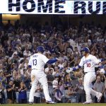 
              Los Angeles Dodgers' Justin Turner, right, is congratulated by Max Muncy as he scores after hitting a two-run home run during the seventh inning of a baseball game against the San Diego Padres Thursday, June 30, 2022, in Los Angeles. (AP Photo/Mark J. Terrill)
            