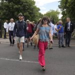 
              Spectators walk to the courts after clearing the security check on day one of the Wimbledon tennis championships in London, Monday, June 27, 2022. (AP Photo/Alastair Grant)
            