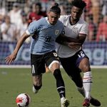 
              Uruguay forward Darwin Nunez (11) and USA defender Erik Palmer-Brown (12) chase the ball during the second half of an international friendly soccer match Sunday, June 5, 2022, in Kansas City, Kan. The match ended in a 0-0 tie. (AP Photo/Charlie Riedel)
            