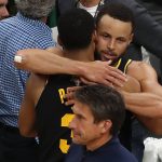 
              Golden State Warriors guard Stephen Curry (30) hugs guard Jordan Poole (3) after beating the Boston Celtics in Game 4 of basketball's NBA Finals, Friday, June 10, 2022, in Boston. (AP Photo/Michael Dwyer)
            