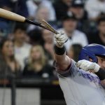 
              Texas Rangers' Kole Calhoun breaks his bat as he hits a foul ball during the fourth inning of a baseball game against the Chicago White Sox in Chicago, Friday, June 10, 2022. (AP Photo/Nam Y. Huh)
            