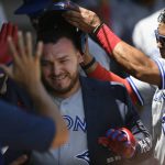 
              Toronto Blue Jays' Alejandro Kirk left, celebrates with teammate Santiago Espinal, right, along with other teammates in the dugout after hitting a solo home run during the third inning of a baseball game against the Chicago White Sox, Wednesday, June 22, 2022, in Chicago. (AP Photo/Paul Beaty)
            