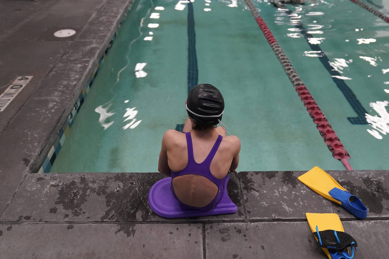 FILE - A 12 year old transgender swimmer is seen waiting by a pool on February 22, 2021 in Utah. Sh...