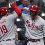 
              Philadelphia Phillies' Matt Vierling (19) is congratulated by Rhys Hoskins after hitting a go-ahead home run during the ninth inning of the team's baseball game against the Milwaukee Brewers on Tuesday, June 7, 2022, in Milwaukee. (AP Photo/Aaron Gash)
            