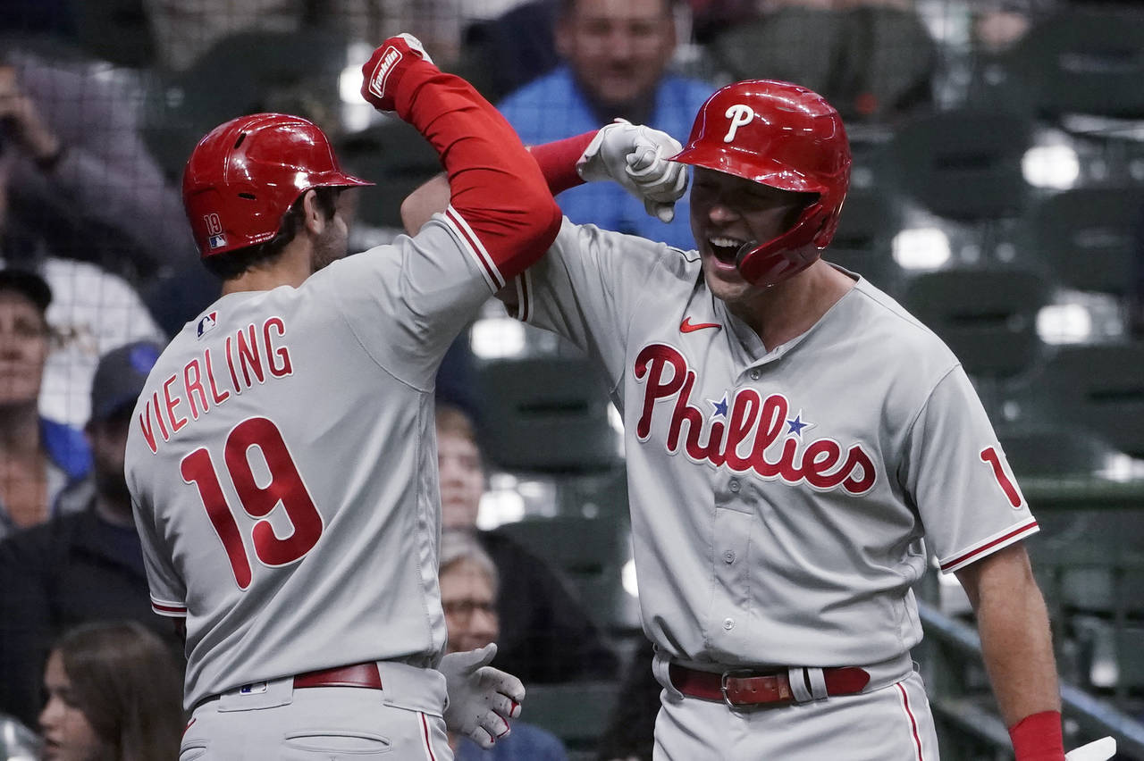 Philadelphia Phillies' Matt Vierling (19) is congratulated by Rhys Hoskins after hitting a go-ahead...