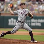 
              Texas A&M pitcher Micah Dallas (34) throws to home against Louisville during an NCAA college baseball super regional tournament game Saturday, June 11, 2022, in College Station, Texas. (AP Photo/Sam Craft)
            