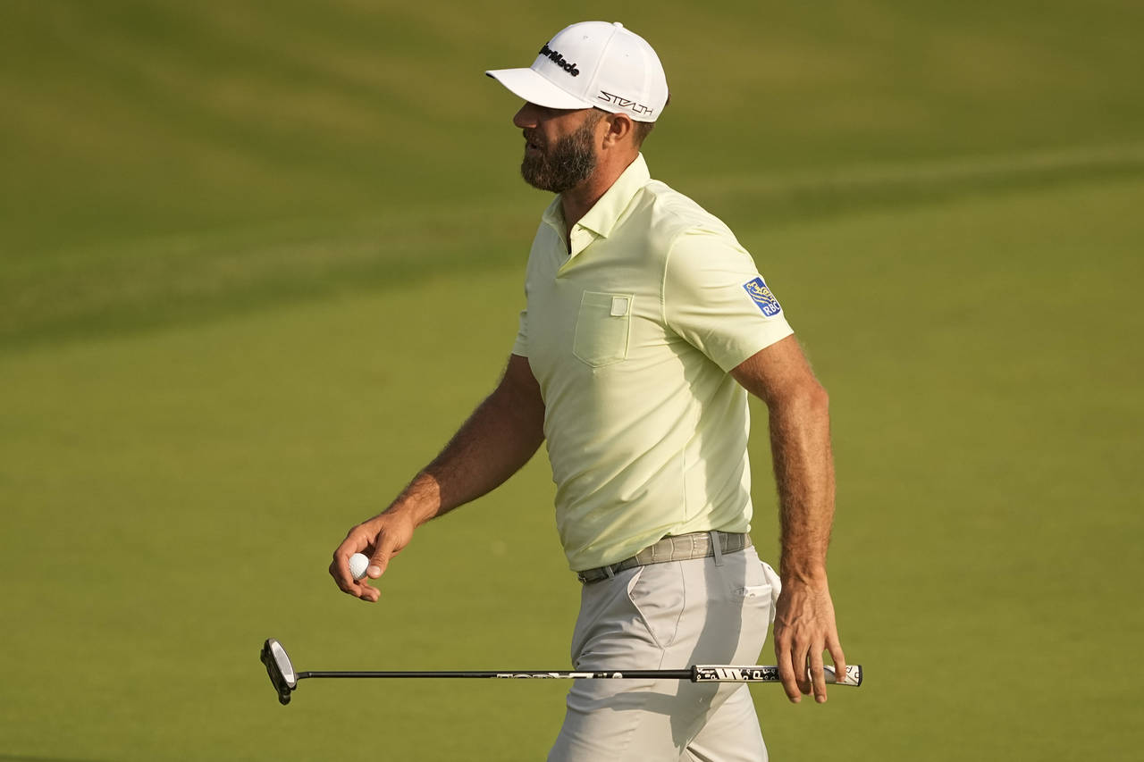 Dustin Johnson reacts after missing a putt on the 10th hole during the second round of the PGA Cham...