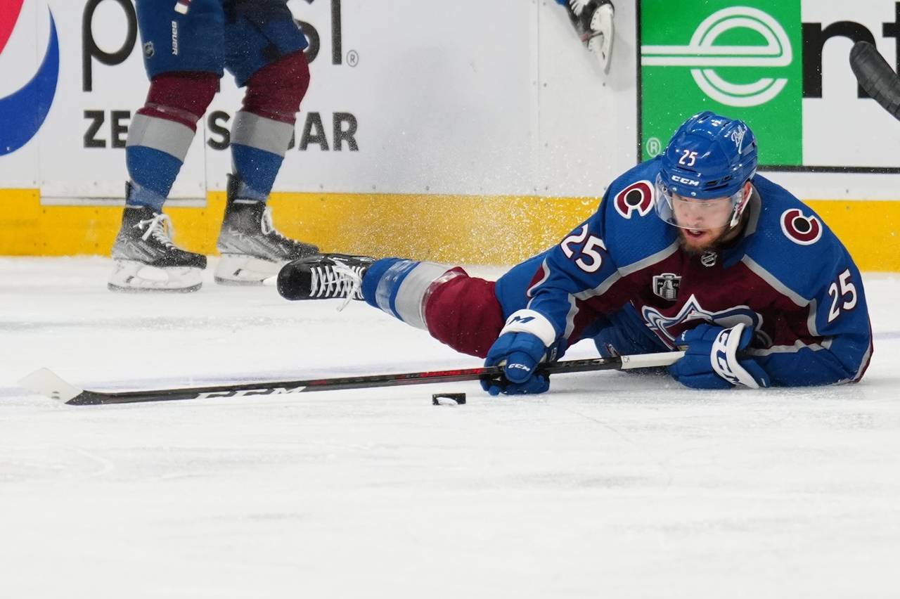 Colorado Avalanche right wing Logan O'Connor (25) tries to control the puck from the ice during the...