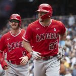 
              Los Angeles Angels' Mike Trout (27) and Taylor Ward (3) look on after scoring on Trout's home run off a pitch from Seattle Mariners starter Logan Gilbert during the fourth inning of a baseball game, June 19, 2022, in Seattle. (AP Photo/John Froschauer)
            