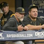 
              Pittsburgh Pirates manager Derek Shelton, front left, talks with Daniel Vogelbach in the dugout during the first inning of a baseball game against the Tampa Bay Rays, Sunday, June 26, 2022, in St. Petersburg, Fla. (AP Photo/Steve Nesius)
            