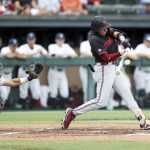 
              Stanford's Brett Barrera hits a double against Connecticut during the first inning of an NCAA college baseball super regional game Sunday, June 12, 2022, in Stanford, Calif. (AP Photo/Kavin Mistry)
            