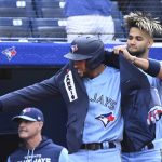 
              Toronto Blue Jays' Lourdes Gurriel Jr., right, puts the home run jacket on George Springer following Springer's solo home run off Minnesota Twins starting pitcher Chi Chi Gonzalez during the first inning of a baseball game Friday, June 3, 2022, in Toronto. (Jon Blacker/The Canadian Press via AP)
            
