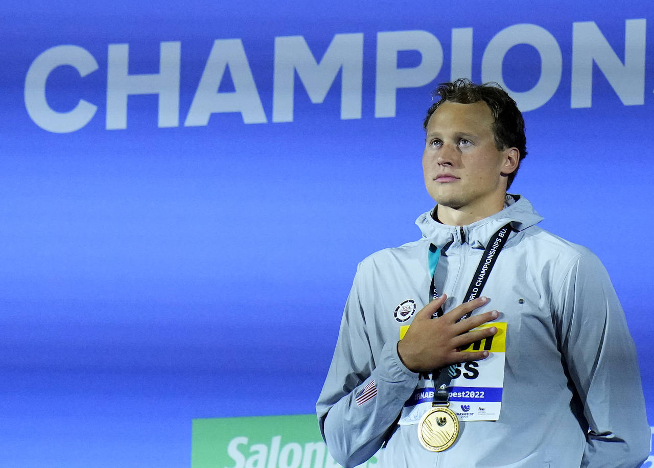 Justin Ress of the United States listens to his national anthem after winning the men's 50m backstr...