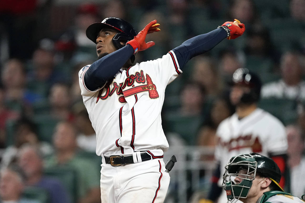 Atlanta Braves' Ozzie Albies watches his three-run home run during the seventh inning of the team's...