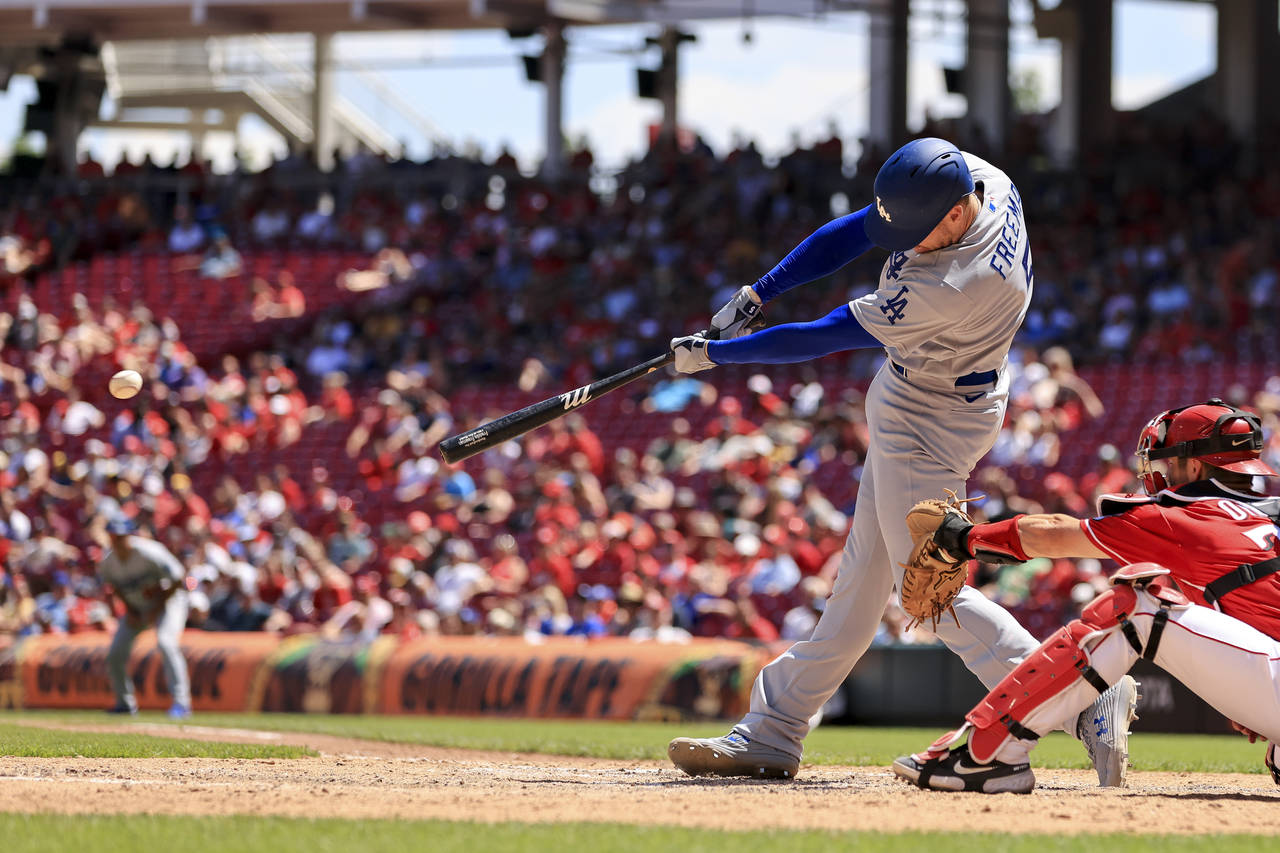 Los Angeles Dodgers' Freddie Freeman hits an RBI single during the eighth inning a baseball game ag...